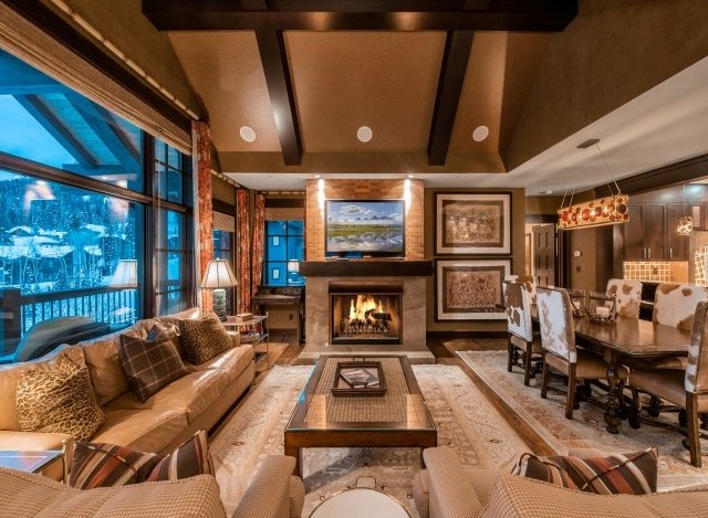 Luxurious mountain lodge with expansive windows offering breathtaking views.