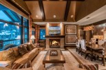 Luxurious mountain lodge with expansive windows offering breathtaking views.