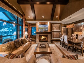 Luxurious mountain lodge with expansive windows offering breathtaking views.