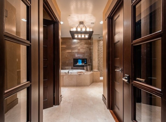 Luxurious bathroom with a stunning fireplace and soaking tub.