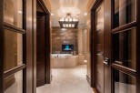 Luxurious bathroom with a stunning fireplace and soaking tub.