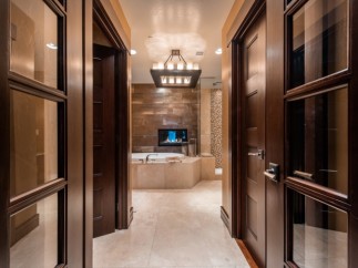 Luxurious bathroom with a stunning fireplace and soaking tub.