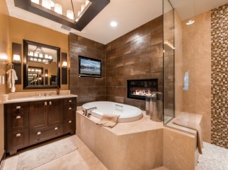 Luxurious bathroom with a built-in fireplace and a large soaking tub.