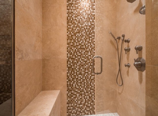 Luxury shower with built-in seat and multiple shower heads.
