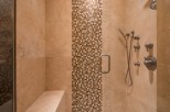 Luxury shower with built-in seat and multiple shower heads.