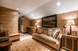 Cozy attic retreat with a plush sofa, perfect for relaxing evenings.