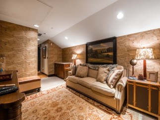 Cozy attic retreat with a plush sofa, perfect for relaxing evenings.