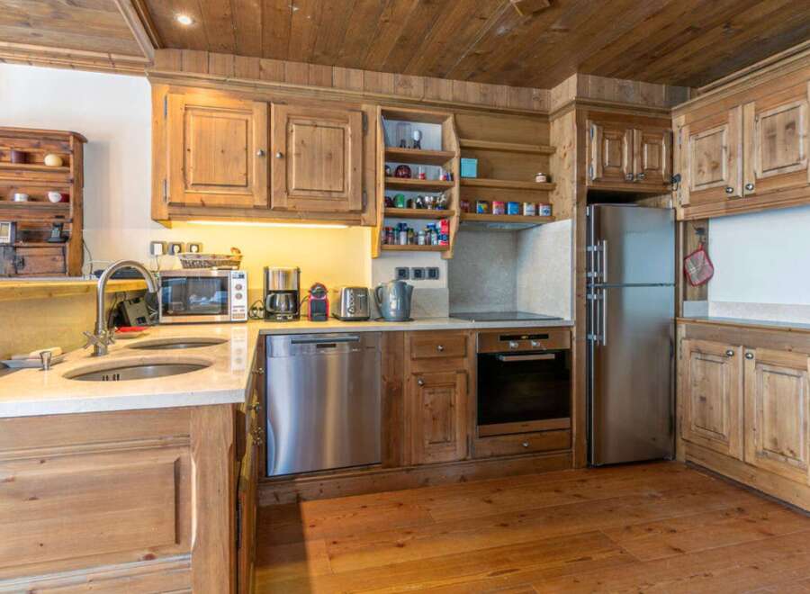 This stunning kitchen boasts a rustic charm with its wooden cabinetry and flooring, creating a warm and inviting atmosphere.