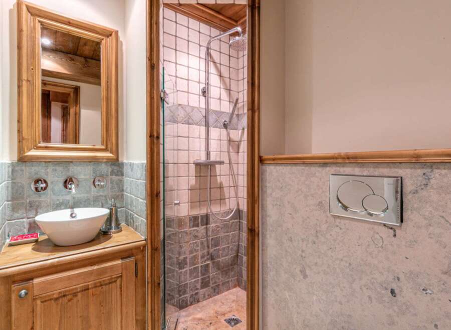 Discover the charm of this beautifully designed bathroom, featuring a stylish vanity and a modern shower.