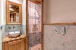Discover the charm of this beautifully designed bathroom, featuring a stylish vanity and a modern shower.