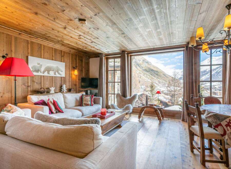 Experience the charm of this cozy chalet, featuring a warm wooden interior and stunning mountain views.