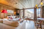 Experience the charm of this cozy chalet, featuring a warm wooden interior and stunning mountain views.