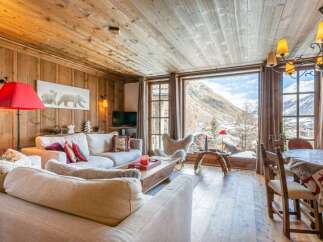 Experience the charm of this cozy chalet, featuring a warm wooden interior and stunning mountain views.