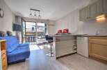 Discover this charming apartment with a cozy living space and a well-equipped kitchenette.