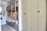 This cozy bedroom features a unique bunk bed design, perfect for maximizing space.
