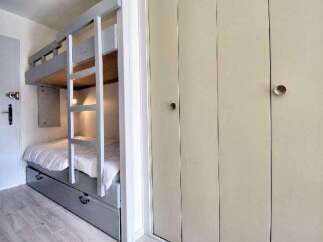 This cozy bedroom features a unique bunk bed design, perfect for maximizing space.