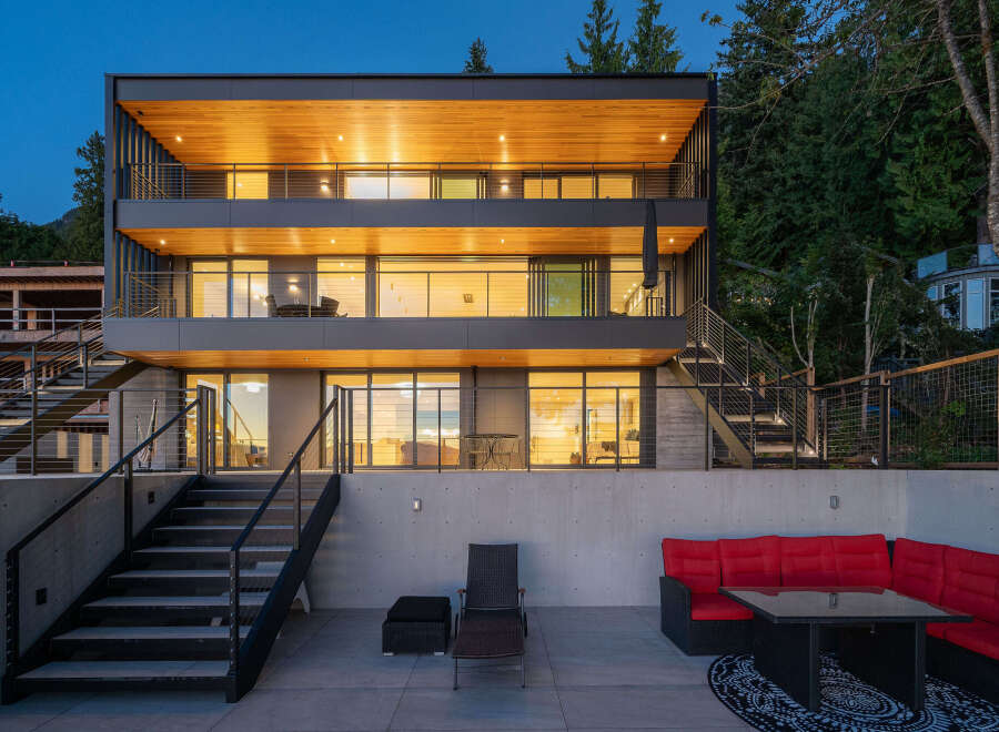 This stunning modern home boasts a sleek design with multiple levels and expansive windows.