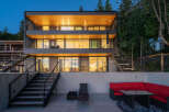 This stunning modern home boasts a sleek design with multiple levels and expansive windows.