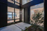 Experience modern luxury in this stunning home featuring sleek black exterior and expansive windows.