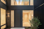 This modern home entrance showcases a sleek design with a focus on natural light.