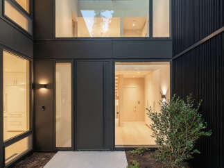 This modern home entrance showcases a sleek design with a focus on natural light.