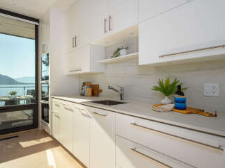 This stunning kitchen boasts modern design and breathtaking views.