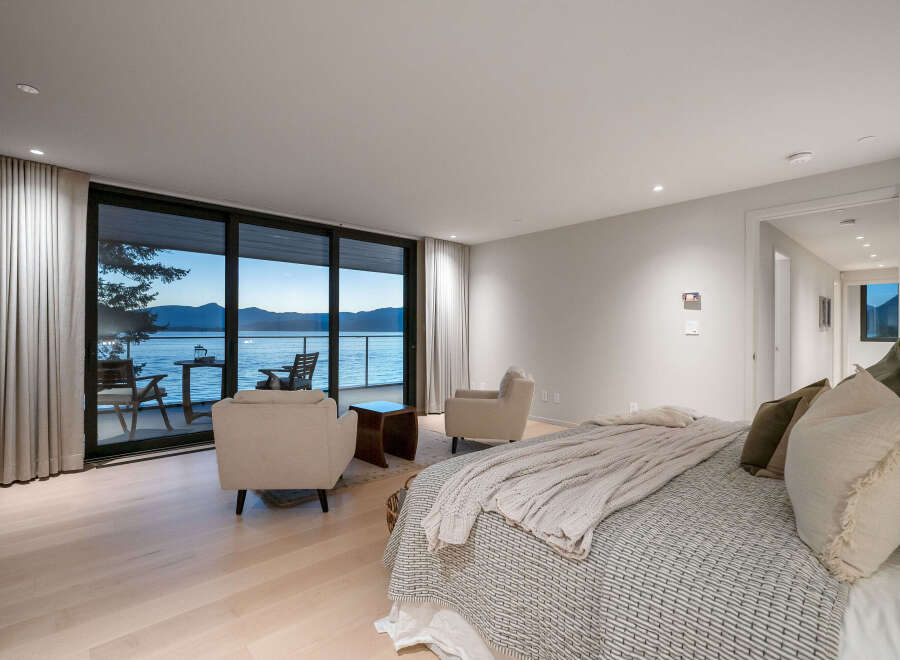 Experience luxury living with this stunning bedroom featuring breathtaking water views.