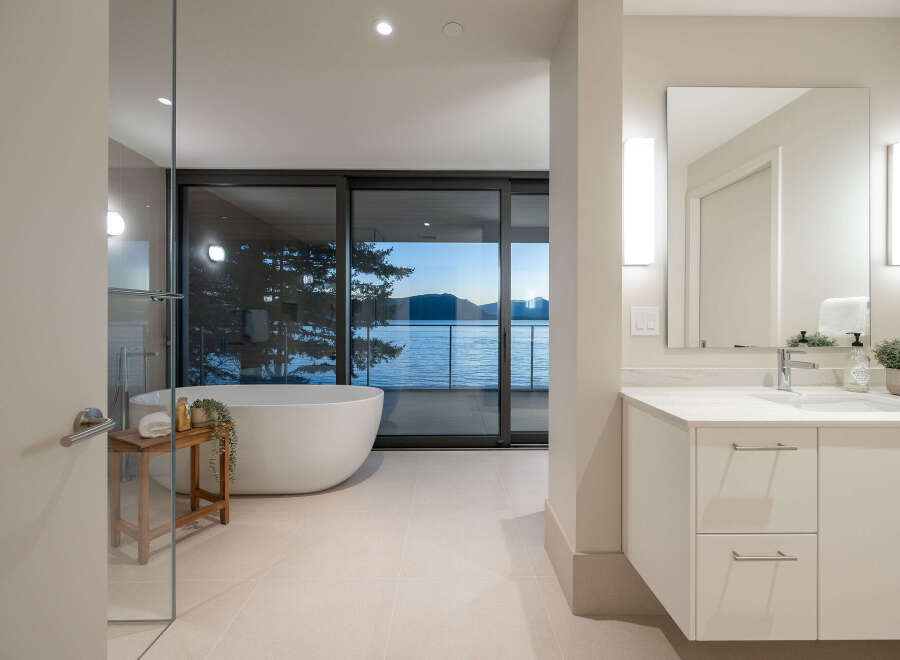 Experience luxury living with this stunning bathroom featuring a modern design and breathtaking water views.