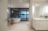 Experience luxury living with this stunning bathroom featuring a modern design and breathtaking water views.