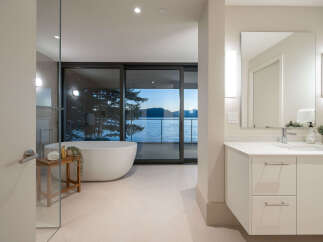Experience luxury living with this stunning bathroom featuring a modern design and breathtaking water views.