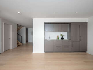 This modern home boasts a sleek, open-concept design with beautiful hardwood floors throughout.