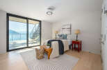 Experience luxury living with this stunning bedroom featuring breathtaking water views.