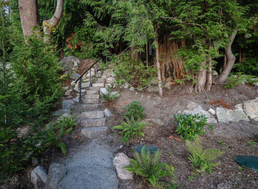 Discover the charm of this property with its inviting stone staircase leading to a hidden oasis.