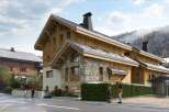 Discover the charm of this stunning chalet-style property, boasting exquisite wooden architecture and a stone facade.