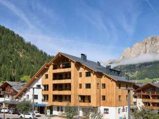 Discover the charm of this stunning property, boasting a unique wooden facade and modern design.