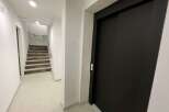 Discover this inviting property featuring a modern elevator and a well-lit staircase.