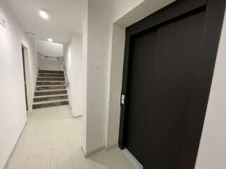 Discover this inviting property featuring a modern elevator and a well-lit staircase.