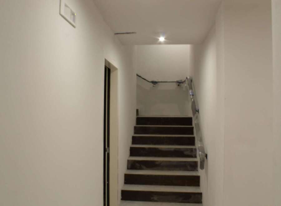 Discover this stunning property featuring a modern staircase leading to the upper levels.
