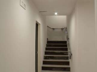Discover this stunning property featuring a modern staircase leading to the upper levels.