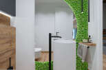 This modern bathroom boasts a unique design with a striking green wall feature.