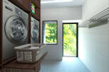 This modern laundry room features sleek Samsung washing machines and ample storage.