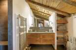 This stunning bathroom showcases rustic charm with its wooden ceiling and cabinetry.