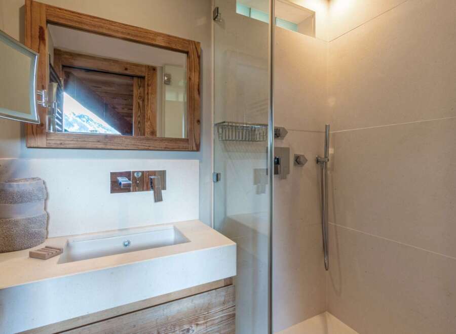 This stunning bathroom features a modern design with a touch of rustic charm.