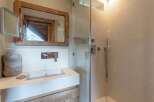 This stunning bathroom features a modern design with a touch of rustic charm.