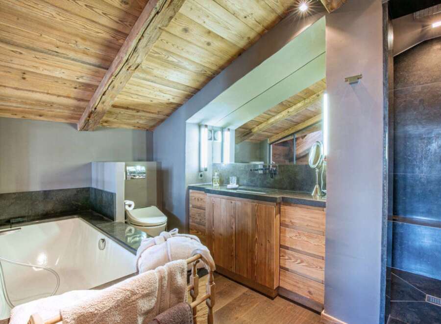 Experience luxury in this stunning bathroom featuring a rustic wooden ceiling and elegant design.