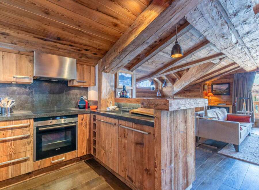 This stunning kitchen boasts a rustic, yet modern design, perfect for a cozy mountain retreat.