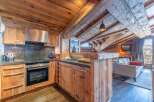 This stunning kitchen boasts a rustic, yet modern design, perfect for a cozy mountain retreat.