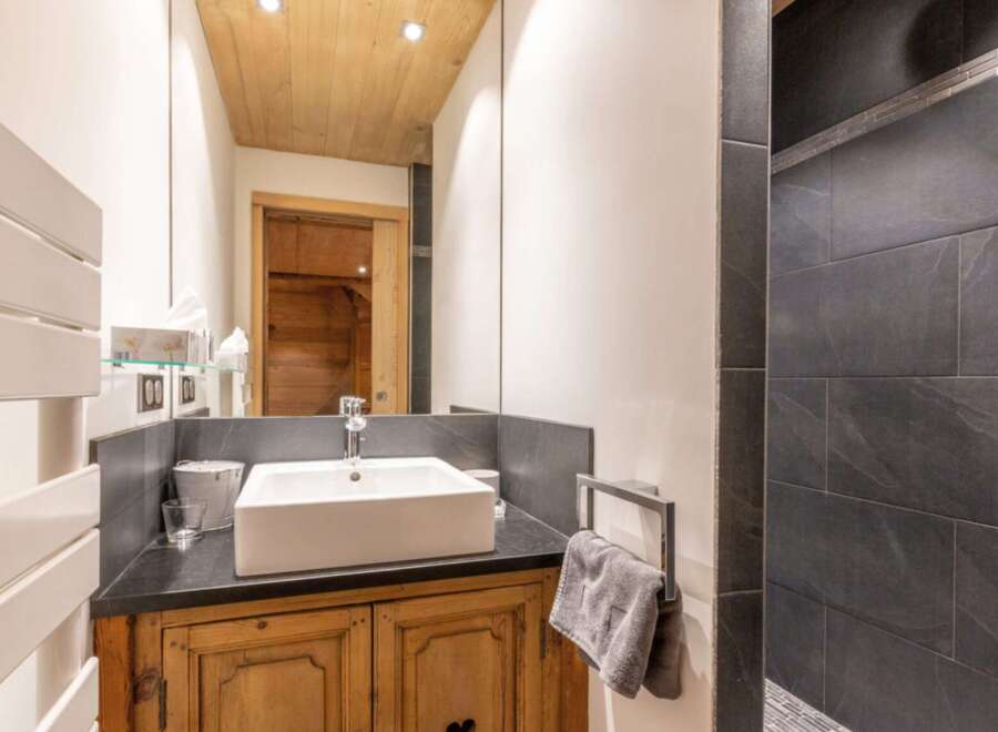 This stunning bathroom showcases a blend of rustic charm and modern elegance.
