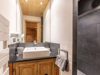This stunning bathroom showcases a blend of rustic charm and modern elegance.