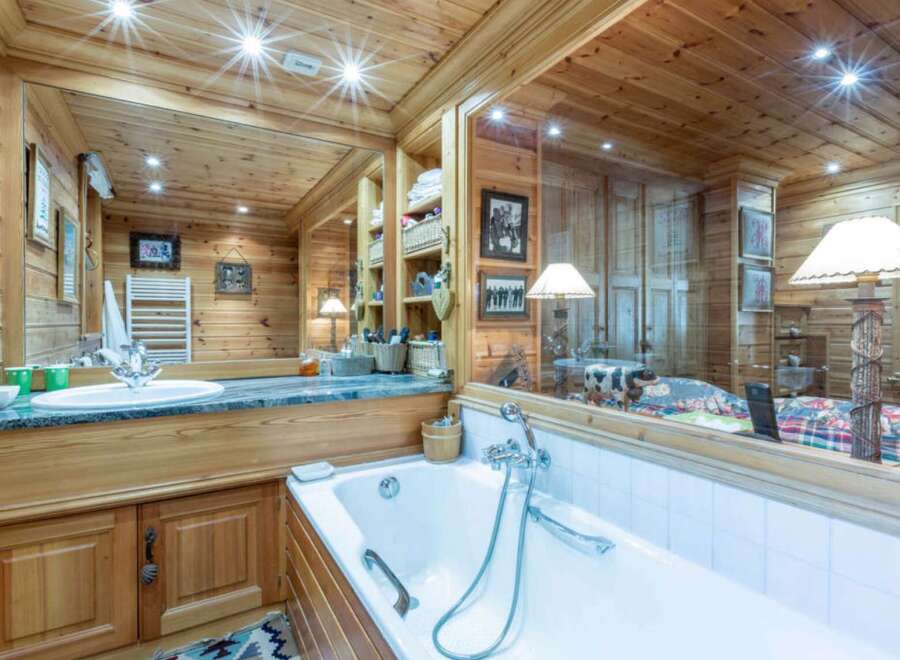 Step into luxury with this stunning bathroom featuring exquisite wooden paneling and a spa-like ambiance.